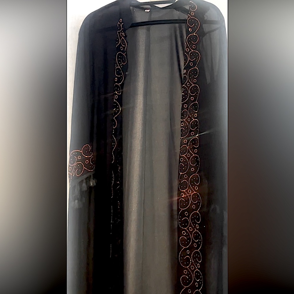 black abaya, kaftan with gold crystal designs going down an around the sleeves